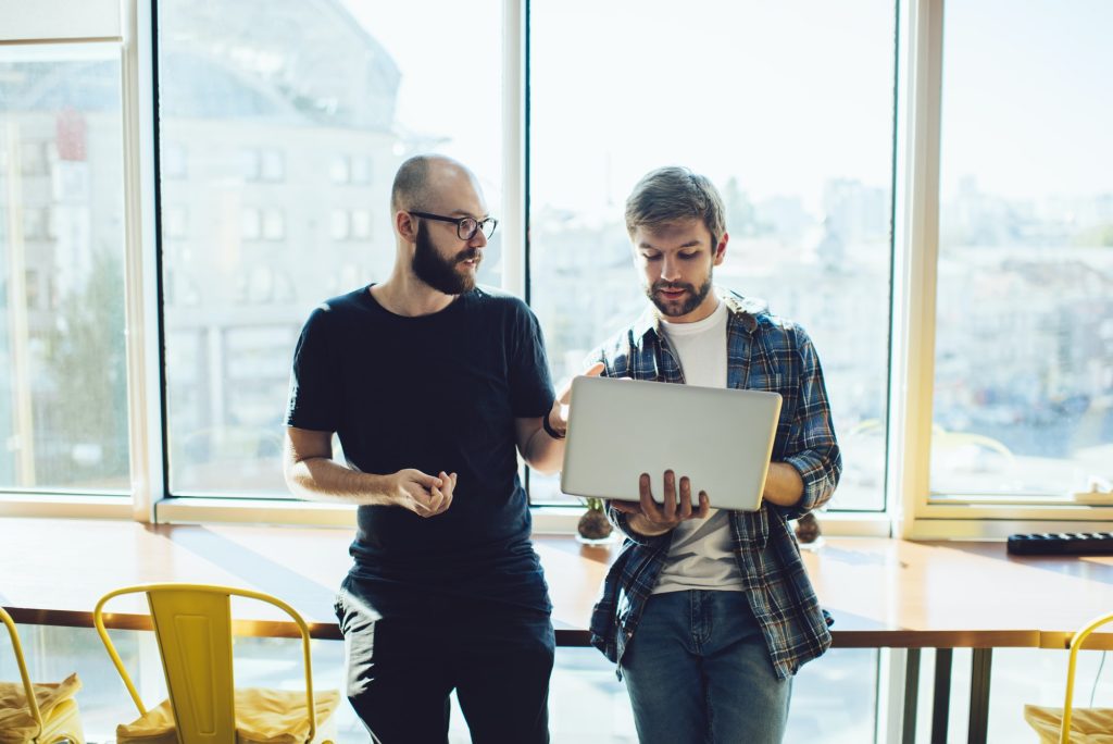 Focused men with laptop investing online